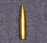 A brass lathe-turned .50 caliber bullet.