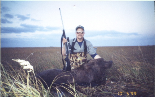 Dan with his 8' bear. There is about a foot and a half of water here. The rifle is a Remington stainless steel 700 action, Lilja stainless steel #4 contour chambered for the 338 Weatherby in a McMillan stock.