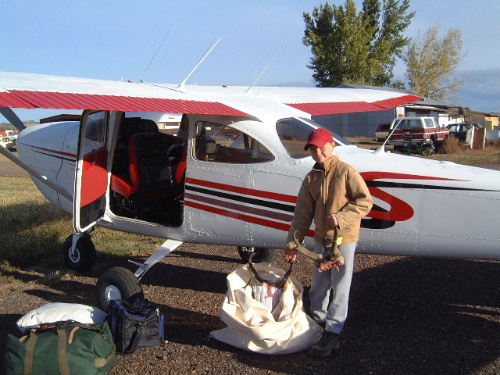 Loading the Cessna T41B at the Broadus, Montana airport following our 2002 antelope hunt.