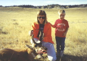 Sally and Adam with a tall buck Sally shot at about 600 yards in 1994. She shot a doe antelope on this hunt too at 955 yards with a Lilja barreled 338/416 Rigby on a Geske action.