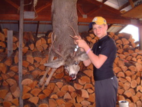 Carson with a big 2-point mule deer buck in October of 2005.