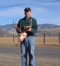 Cory Ovit holds a nice whitetail buck he shot in the 2001 Montana season. Cory laps and flutes barrels.
