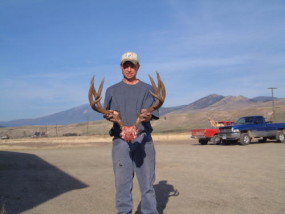 Cory with a heavy antlered 4-point mule deer he shot with his 300 Win Mag.