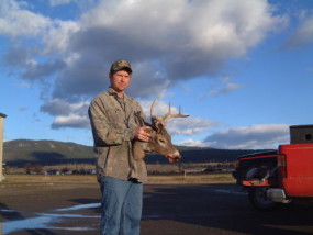 Cory with a nice 4-point buck with an odd main beam on one side. He shot it after work one evening.