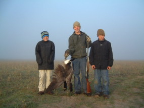 Travis, Adam and Carson after their first morning of goose hunting on opening day of 2004. We got more wing shooting over our barley field but just one goose fell on this foggy morning.