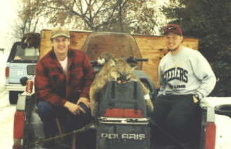 Matt Cockrell and Cory Ovitt with Matt's lion. Matt does all of our drilling and Cory laps barrels. Shot around 1998.